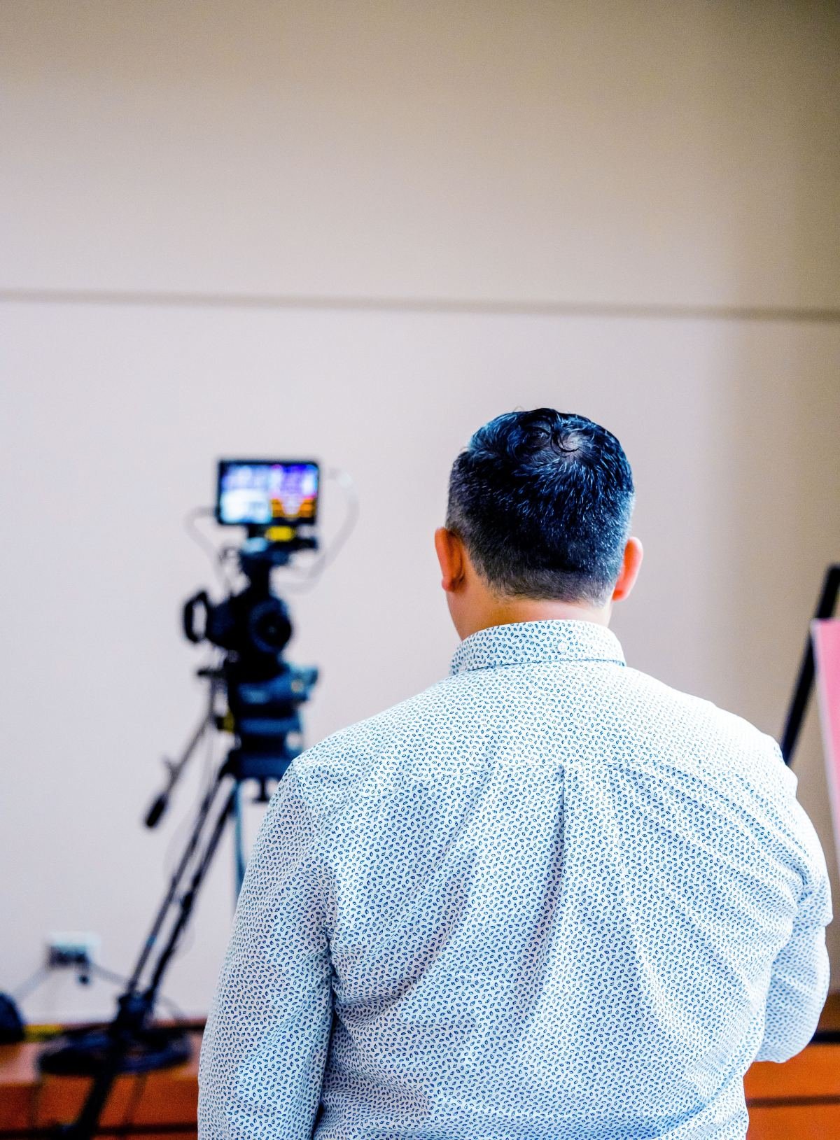 A crew directing a client through a take on a London film set